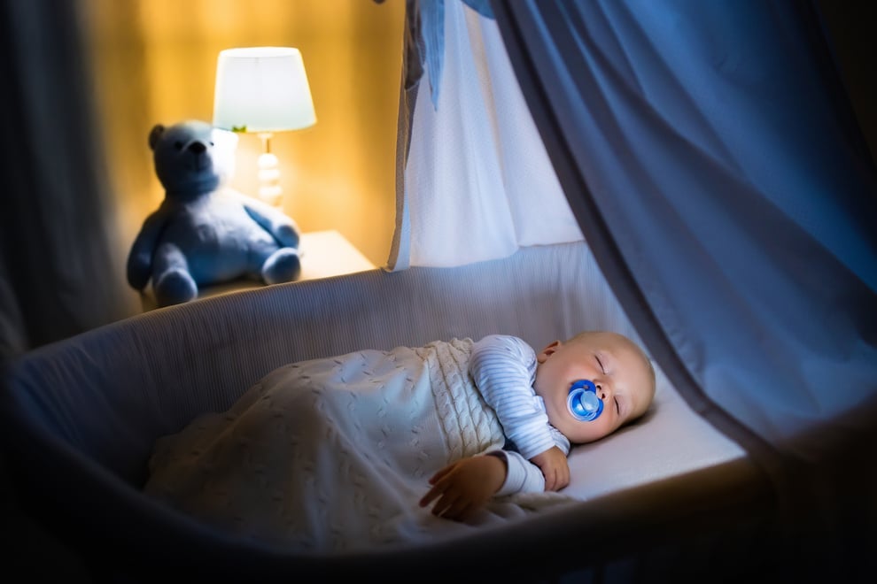 Adorable baby boy sleeping at night